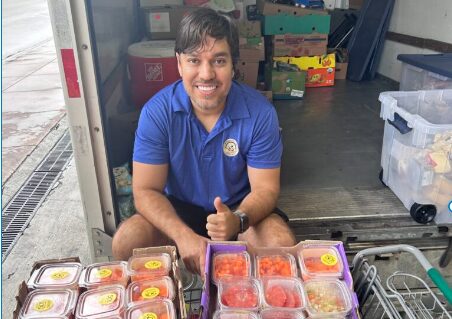 Volunteer with donated food in Miami